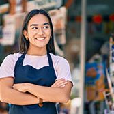 Young,Latin,Shopkeeper,Girl,With,Arms,Crossed,Smiling,Happy,At Young latin shopkeeper girl with arms crossed smiling happy at the press shop