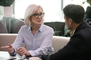 Concentrated,Diverse,Businesspeople,Sit,At,Desk,Talk,Brainstorm,Consider,Project